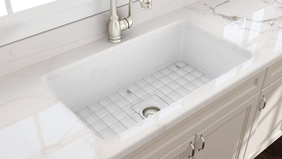 Butler sink and mixer installed in a light kitchen