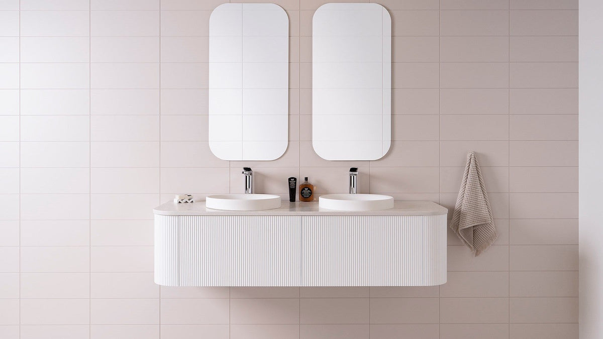 Wall-hung vanity with twin mirrors in a styled bathroom